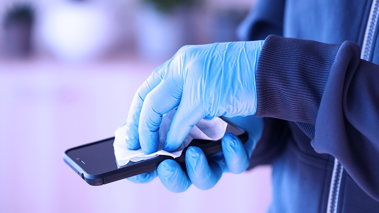 как почистить мобильный. протирать телефон. как почистить мобильный. как почистить мобильный. айфон в руке.